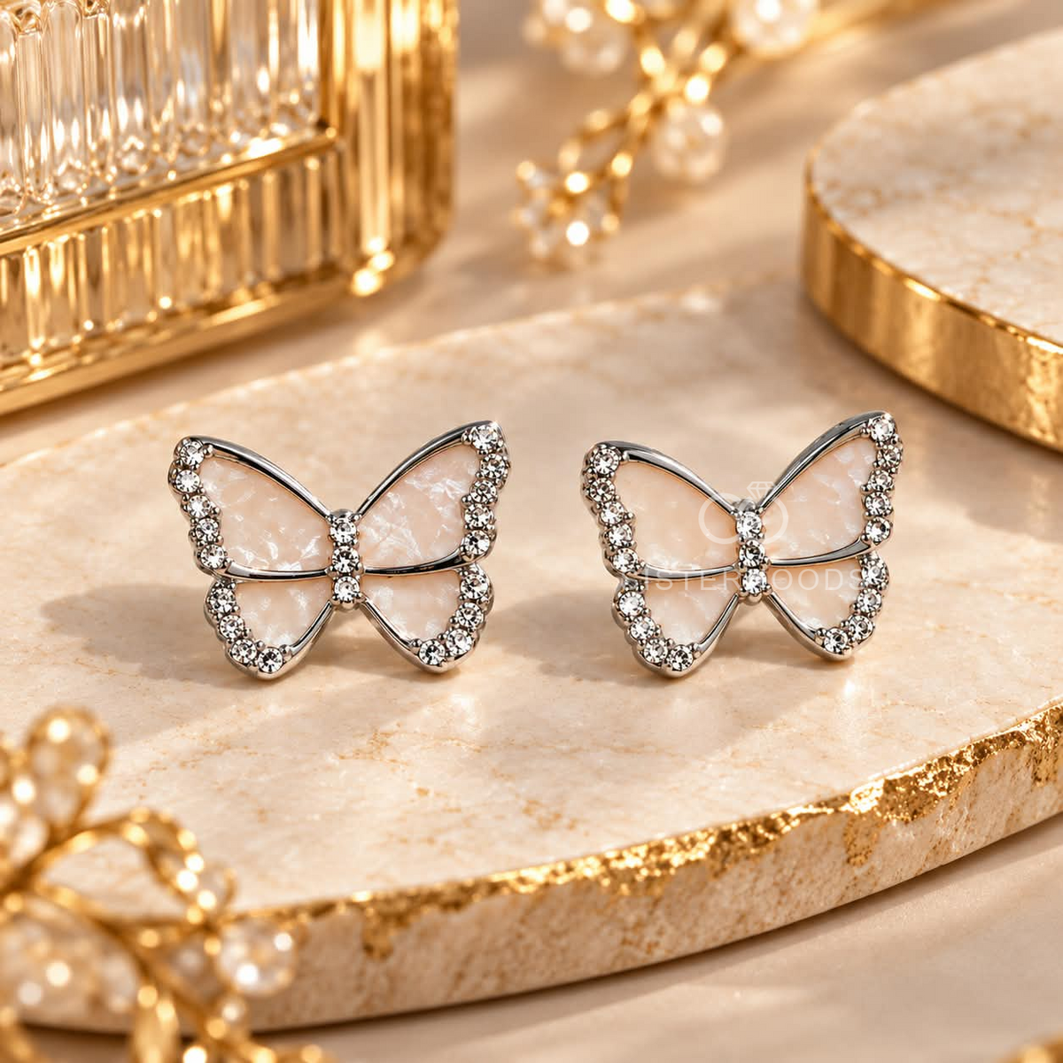 Pale pink butterfly stud earrings with sparkling silver-tone borders | SISTERHOODS-SHA256:7be70c849b43943ef0de6d88a6ce7d838b1ef7dc2c7def2fcae691e2fffcf957
