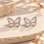 Pale pink butterfly stud earrings with sparkling silver-tone borders | SISTERHOODS-SHA256:beb443f29a8a85814870519b4bb53778ebc65c2c4b3a46f24cc4643e0d9089c4