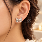 Pale pink butterfly stud earrings with sparkling silver-tone borders | SISTERHOODS-SHA256:fafc5084410ba123b93cafa61f786b6e26eb41b10d3c904541b99c240a1501c0