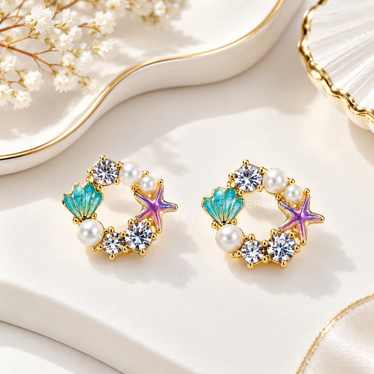 Multicolour pearl stud earrings with turquoise shells, purple starfish and sparkling accents | SISTERHOODS-SHA256:995c33602fa9f6e6f7142bab67707ef5b642d4e7160585e2f526eb446ec251d2