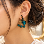 Ornate peacock motif dangle earring with teal accents and black detailing | SISTERHOODS-SHA256:e68da27bf1460c9a1af9bd3b678034e2ee1045516b3a1ad28654282ffb1d455e
