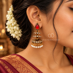Gold-tone jhumka earrings with red teardrop accents, clear stones and white pearl drops | SISTERHOODS-SHA256:1d36044bfefc1fe267e265db6c94115ea5105d68238ae1d222a0eef43987adc4