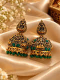 Ornate oxidized jhumka earrings with goddess motifs and green bead drops | SISTERHOODS-SHA256:6a72bda11e06c70a2606a7357177e5efd3ca9b28abf4b8c51e4e275a7e79593b