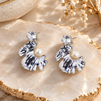 Black and white shell-inspired dangle earring with pearl accent and sparkling stud | SISTERHOODS-SHA256:1fd4e7426e82975280f380dd9c8b62b6113eedd6f98760fafab47a967ca60061