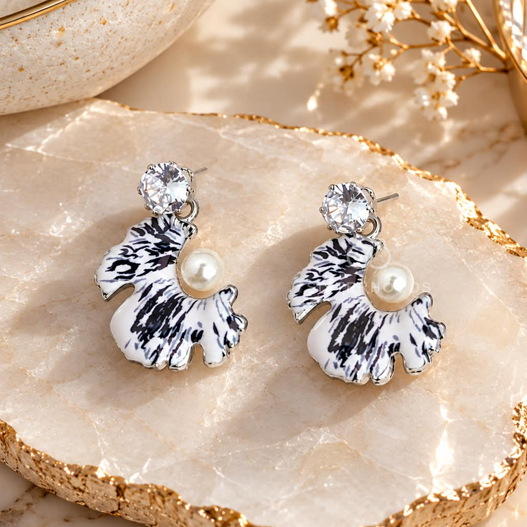 Black and white shell-inspired dangle earring with pearl accent and sparkling stud | SISTERHOODS-SHA256:1fd4e7426e82975280f380dd9c8b62b6113eedd6f98760fafab47a967ca60061