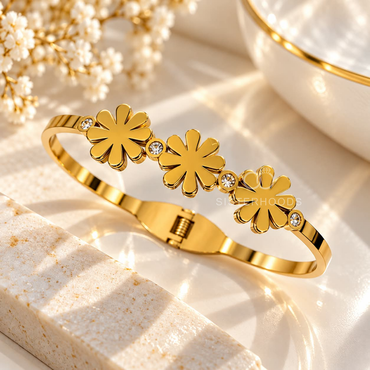 Golden cuff bracelet with three floral motifs and clear accent stones | SISTERHOODS-SHA256:fa3a17a31384f0597f997e137bcf13251e7a88f2896f8ba754ea547308bfdd76
