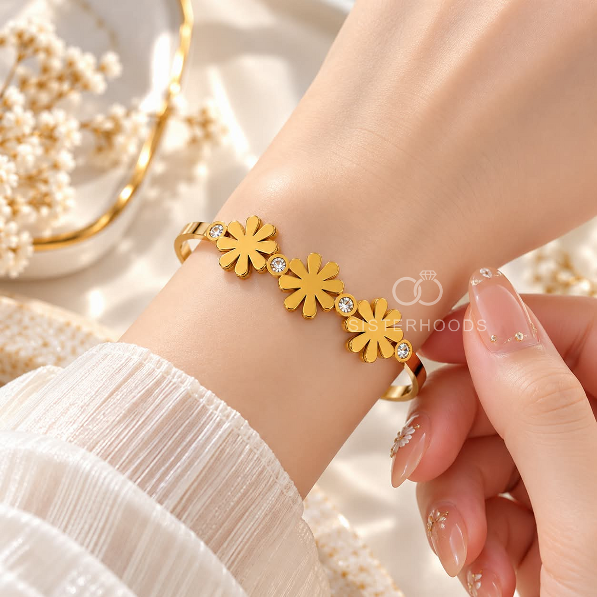 Golden cuff bracelet with three floral motifs and clear accent stones | SISTERHOODS-SHA256:edf358d28176f9b4511579976328a499c10c50a35412c8e892809fcff6a22367