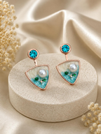 Turquoise triangular drop earrings with blue studs, white centre details and botanical accents | SISTERHOODS-SHA256:99e086534f748ed4fbc2f6de8135ded4e5a114a85b471902ac68966fbd9e16fc