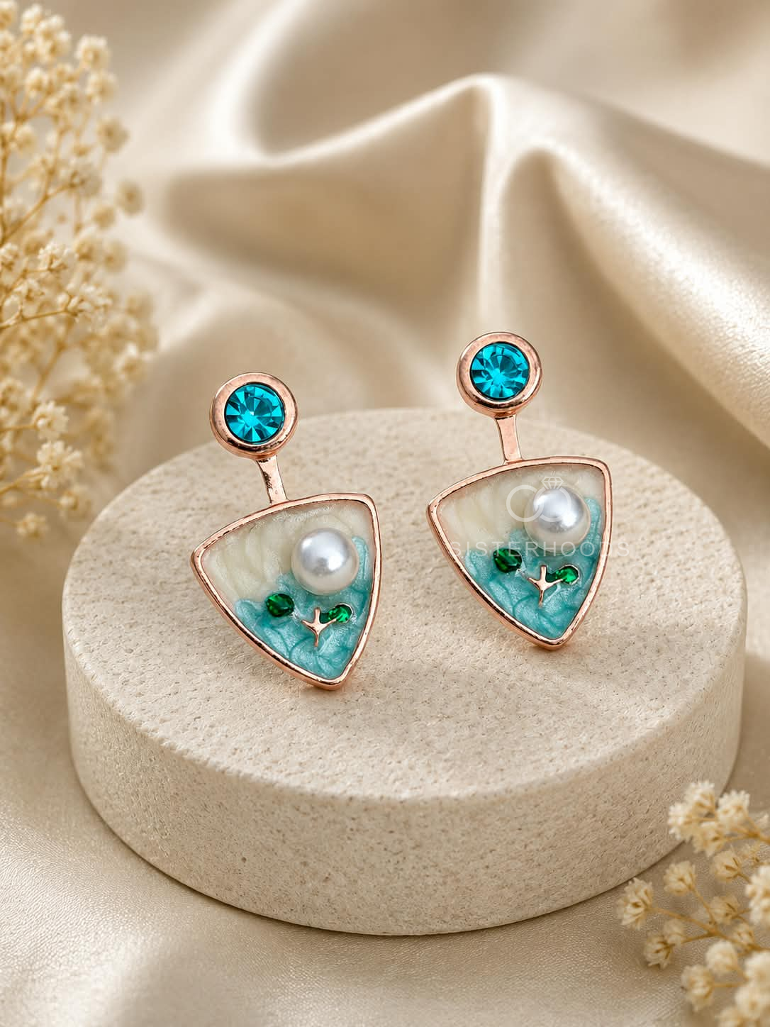 Turquoise triangular drop earrings with blue studs, white centre details and botanical accents | SISTERHOODS-SHA256:99e086534f748ed4fbc2f6de8135ded4e5a114a85b471902ac68966fbd9e16fc