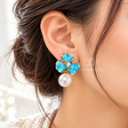 Turquoise floral drop earrings with clear centre accents and white pearl pendants | SISTERHOODS-SHA256:2dd9b05eed864c3edb6a640e80efaff34171a14f33d8c72cfe0d42ef069d03b4