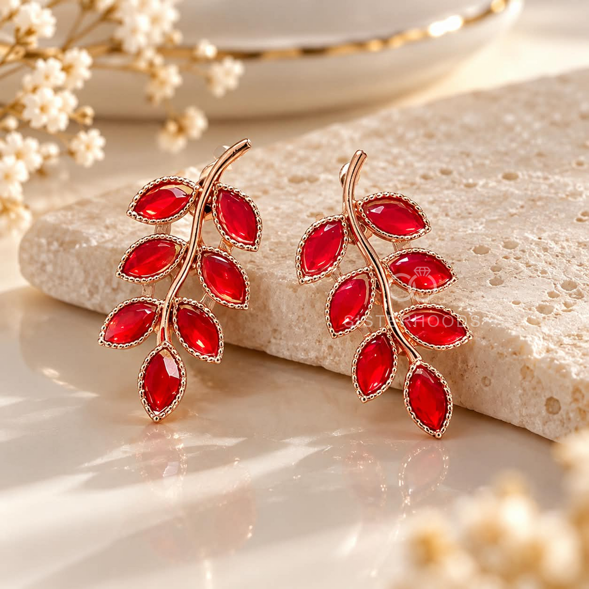 Red faceted leaf branch stud earrings with a curved rose gold-tone design | SISTERHOODS-SHA256:d24fd72a2d06af24e51d5d0ac2bd89fd4146c5b354652fa1faee39b18a10f374