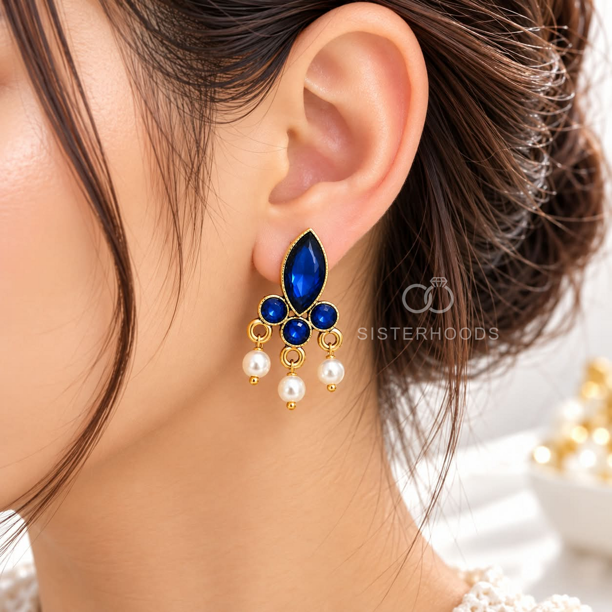 Blue floral dangle earring with white bead accents and gold-tone detailing | SISTERHOODS-SHA256:303da0a46200b8248931493cf03500983dbfb9dfd7a36122a5b0cbeaed74f3c0