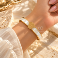 Gold-tone open cuff bracelet with white central band and portrait motif | SISTERHOODS-SHA256:a8fbbe1d6cbc203b123769514bb36d55526277c6ee49b95b035f592d8b8f5c85