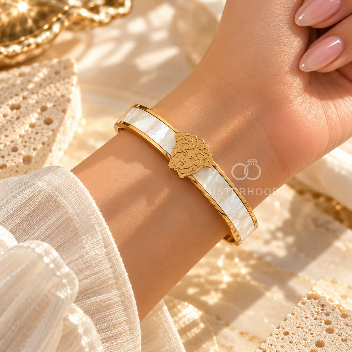 Gold-tone open cuff bracelet with white central band and portrait motif | SISTERHOODS-SHA256:a8fbbe1d6cbc203b123769514bb36d55526277c6ee49b95b035f592d8b8f5c85