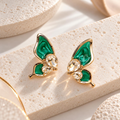 Green butterfly stud earrings with faceted clear accents and gold-colour detailing | SISTERHOODS-SHA256:0a70703ed87642344c44ce465e0b01b5df2ba7cd56ff6f119256c87a3cc5e2a8