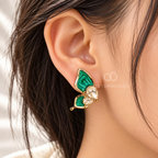 Green butterfly stud earrings with faceted clear accents and gold-colour detailing | SISTERHOODS-SHA256:b8819da8768b2f6010de552729f586f3a28bbaa50db014b7fb6cd9ac4071daa5