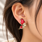 Red wing-shaped stud earrings with clear faceted accents | SISTERHOODS-SHA256:e088e6bb8ddbe8669265ff113eebc4e793bfb266f5bdd550c711b247931fe12d