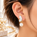White wing-shaped dangle earring with sparkling accents and a pearl drop | SISTERHOODS-SHA256:8f67333967e8b3b78427343d7c95906b079cc4c5d703b846c2afe5f442604772