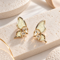 Gold-coloured butterfly stud earrings with cream wings and faceted clear accents | SISTERHOODS-SHA256:9db7d92af2b9f49d1a9fa989f0c085402930493560c3fa9814d52f8dce9fa6b6